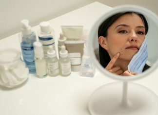 Essential Oils for Acne: The Unbeatable Power of Plants, at Your Service Woman struggling with mask and acne
