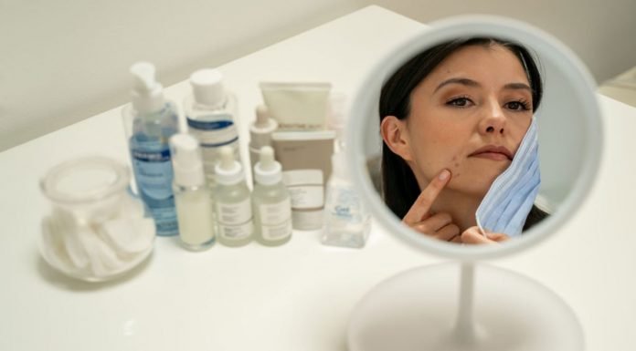 Essential Oils for Acne: The Unbeatable Power of Plants, at Your Service Woman struggling with mask and acne