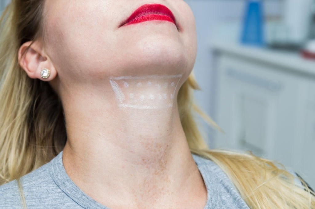 Woman doing facial exercise with ball